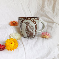 carved magpie mug