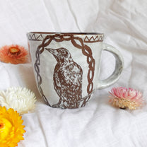 carved magpie mug