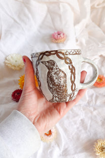 carved magpie mug