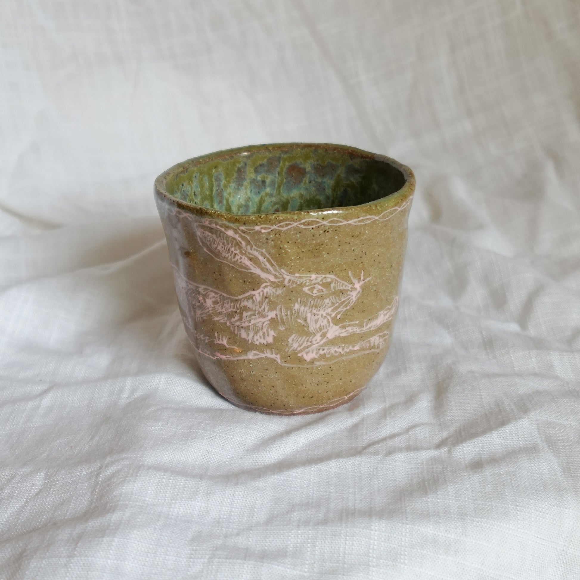 hare on a river rock. cup