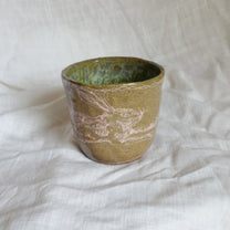 hare on a river rock. cup